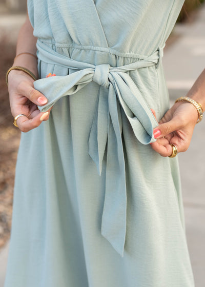 Close up of the tie at the waist on the sage formal dress