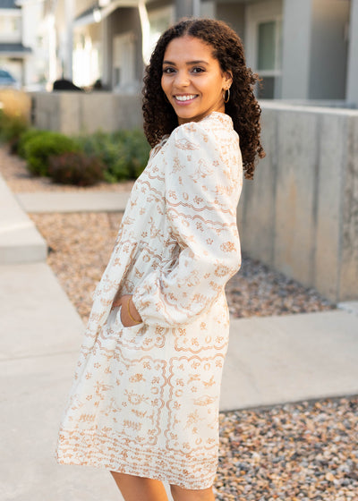 Side view of the modest cream pattern dress with pockets