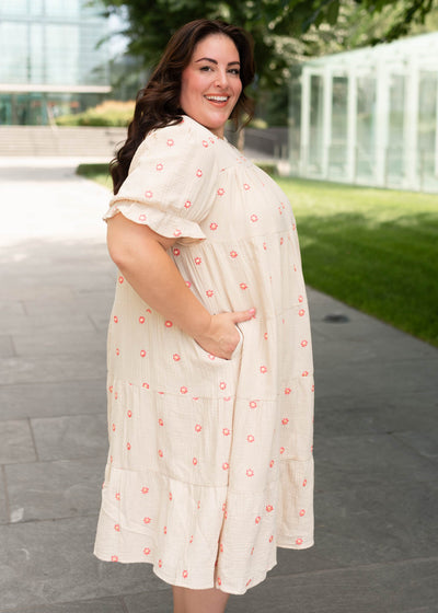 Side view of teh plus size beige floral embroidered dress