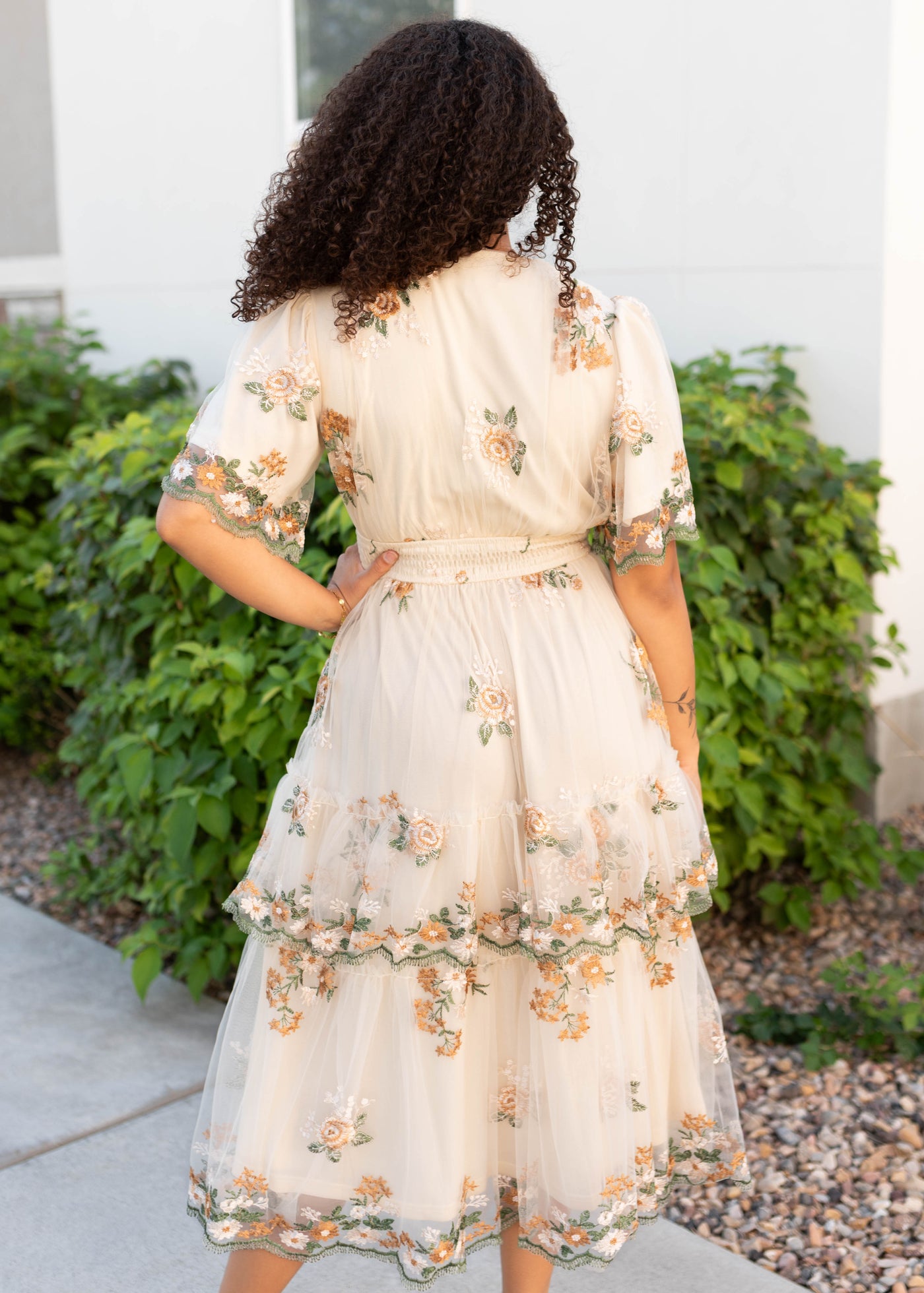 Back view of the modest wild flower taupe dress with embroidery