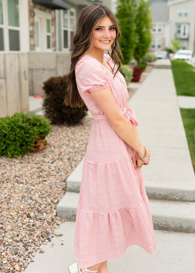 Side view of the blush pink tie waist dress