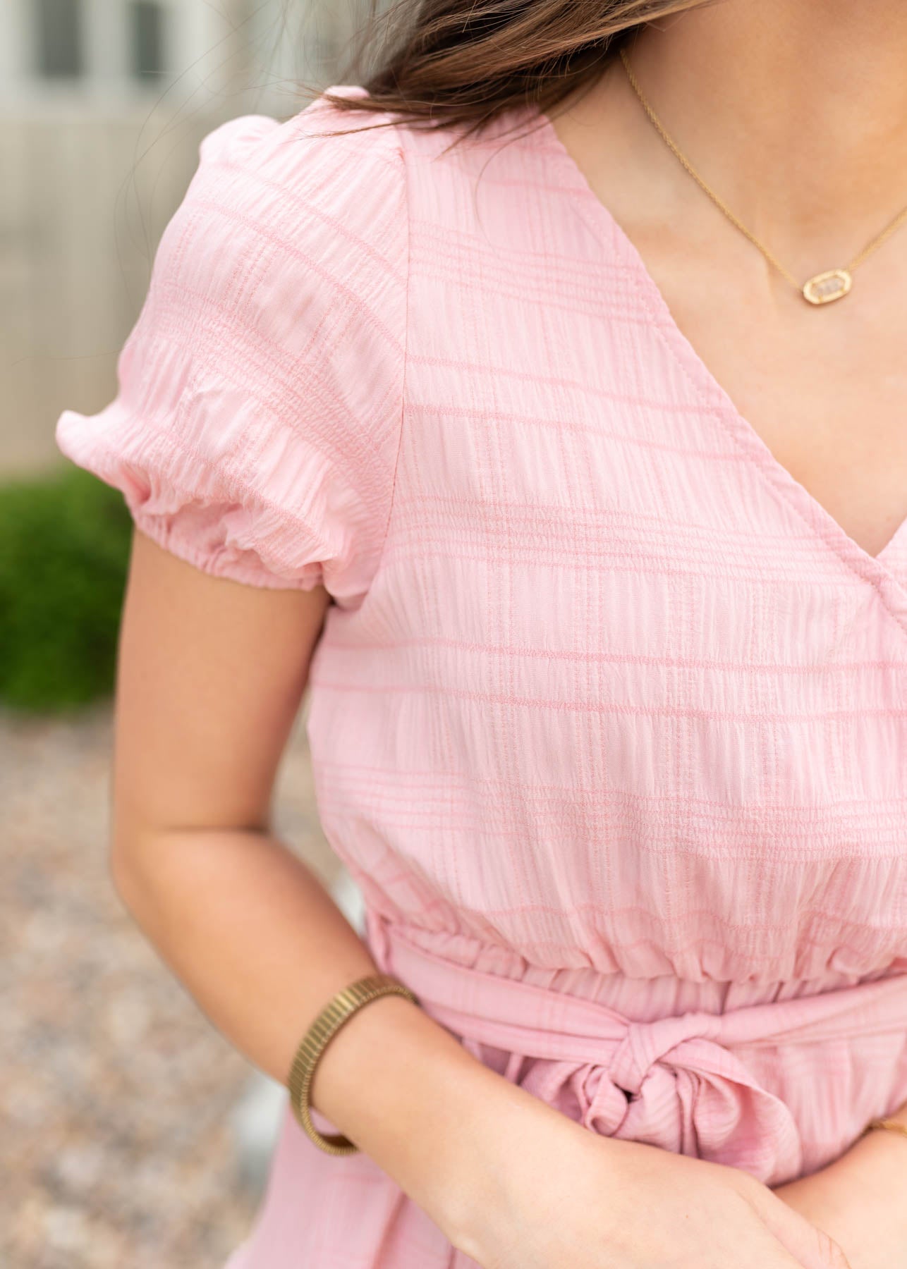 Close up of the fabric on the blush pink tie waist dress