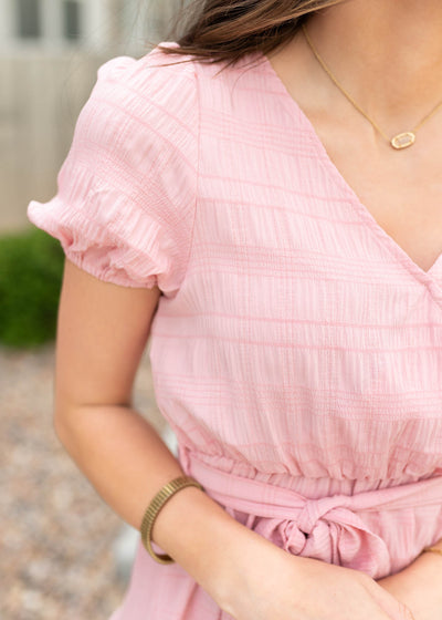 Close up of the fabric on the blush pink tie waist dress