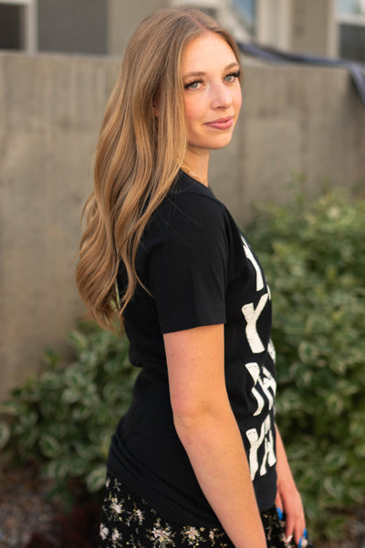 Side view of a y'all black tee