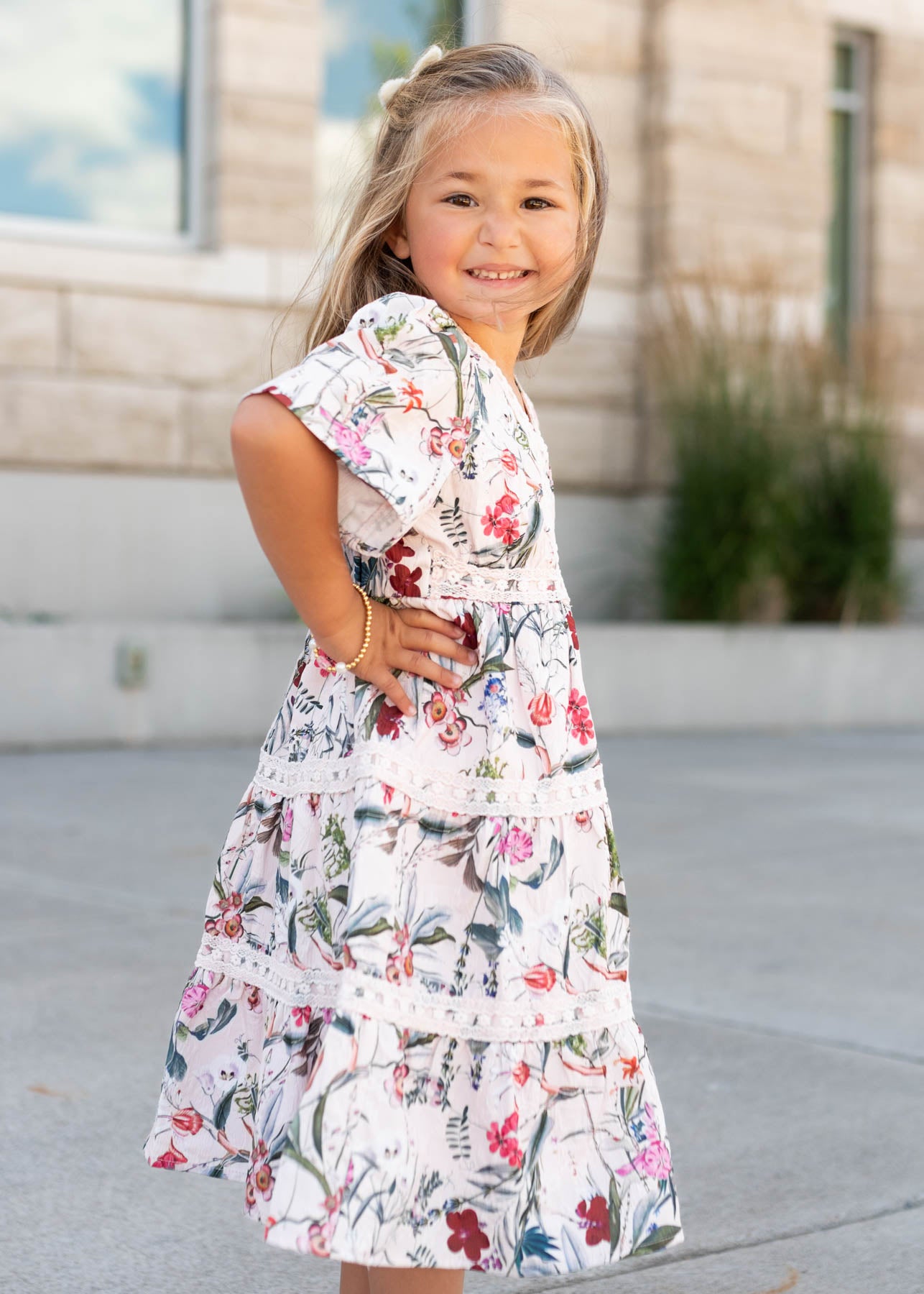 Side view of the pink floral tiered little girl dress by Lena Lou