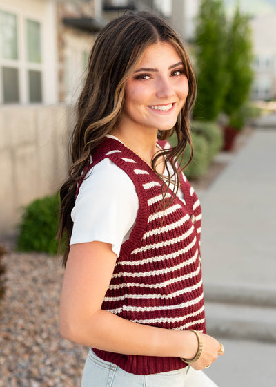 Side view of the burgundy striped sweater vest