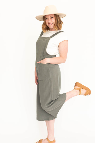 Side view of a dark sage jumpsuit