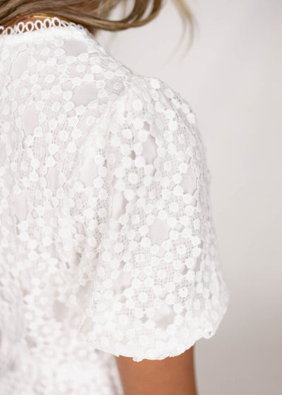 Sleeve of a white lace dress