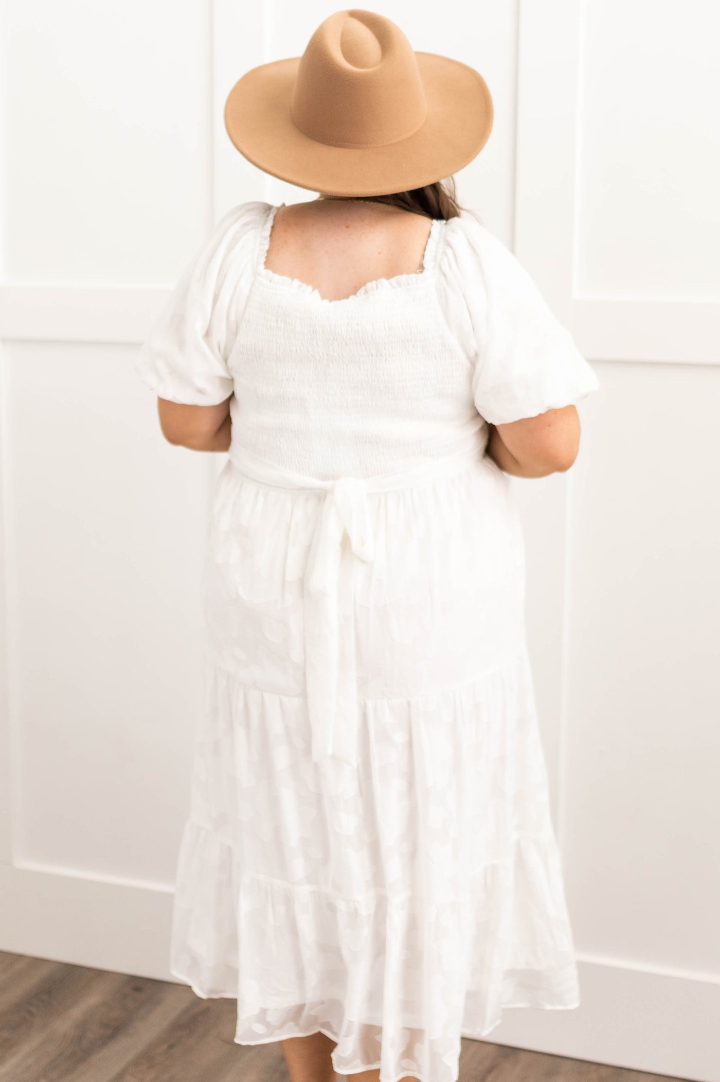 Back view of a plus size white dress that ties in the back