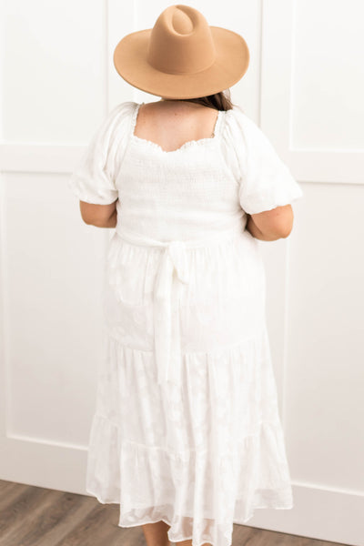 Back view of a plus size white dress that ties in the back