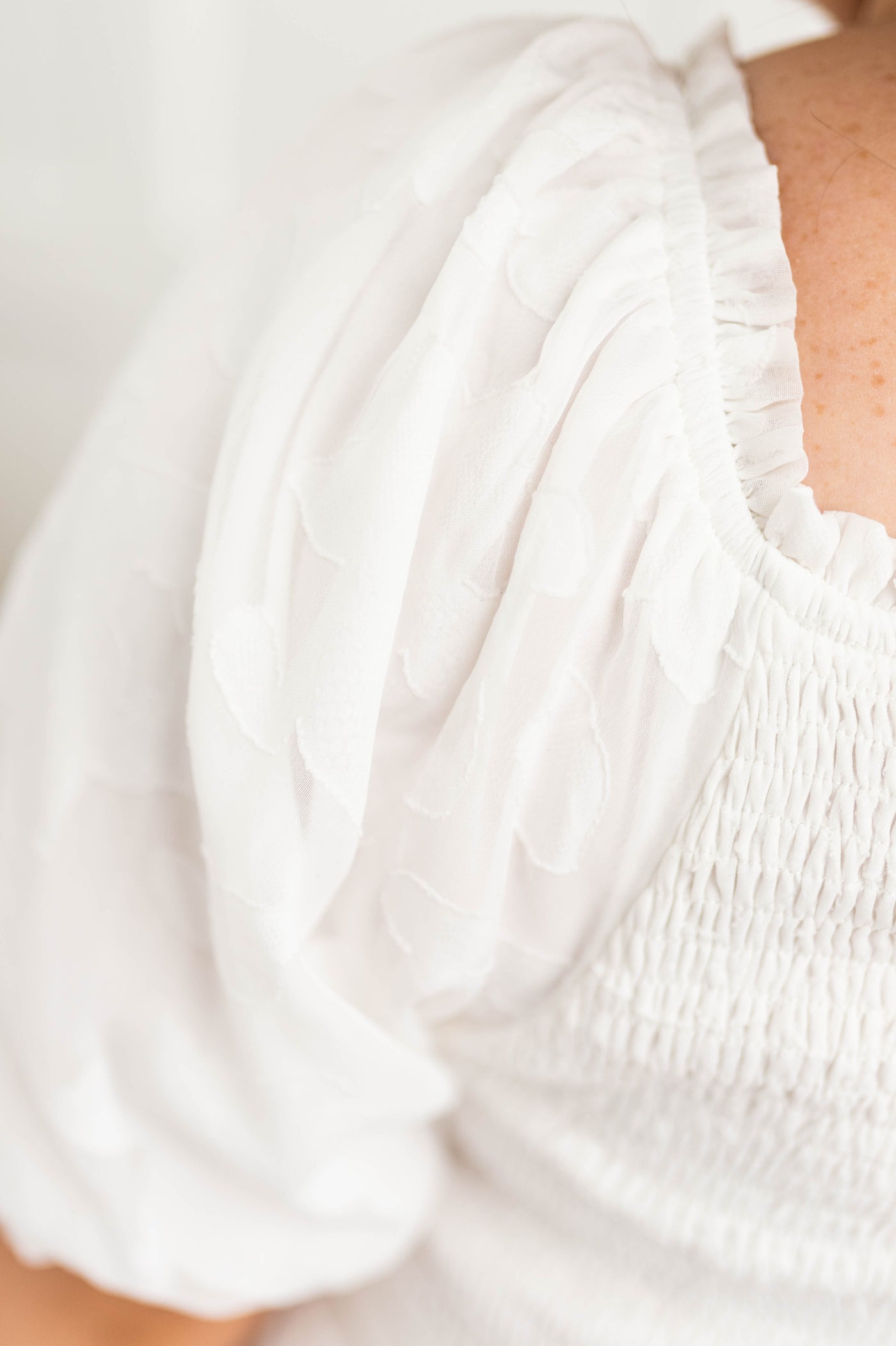 Sleeve of a plus size white dress