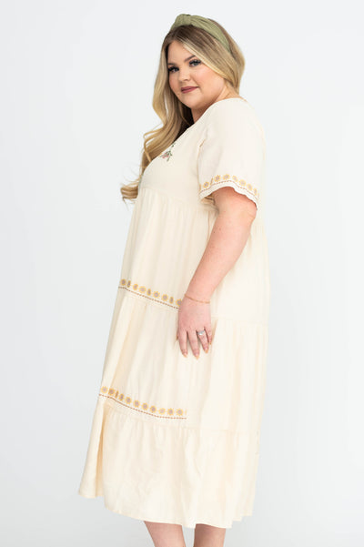 Side view of a plus size cream dress