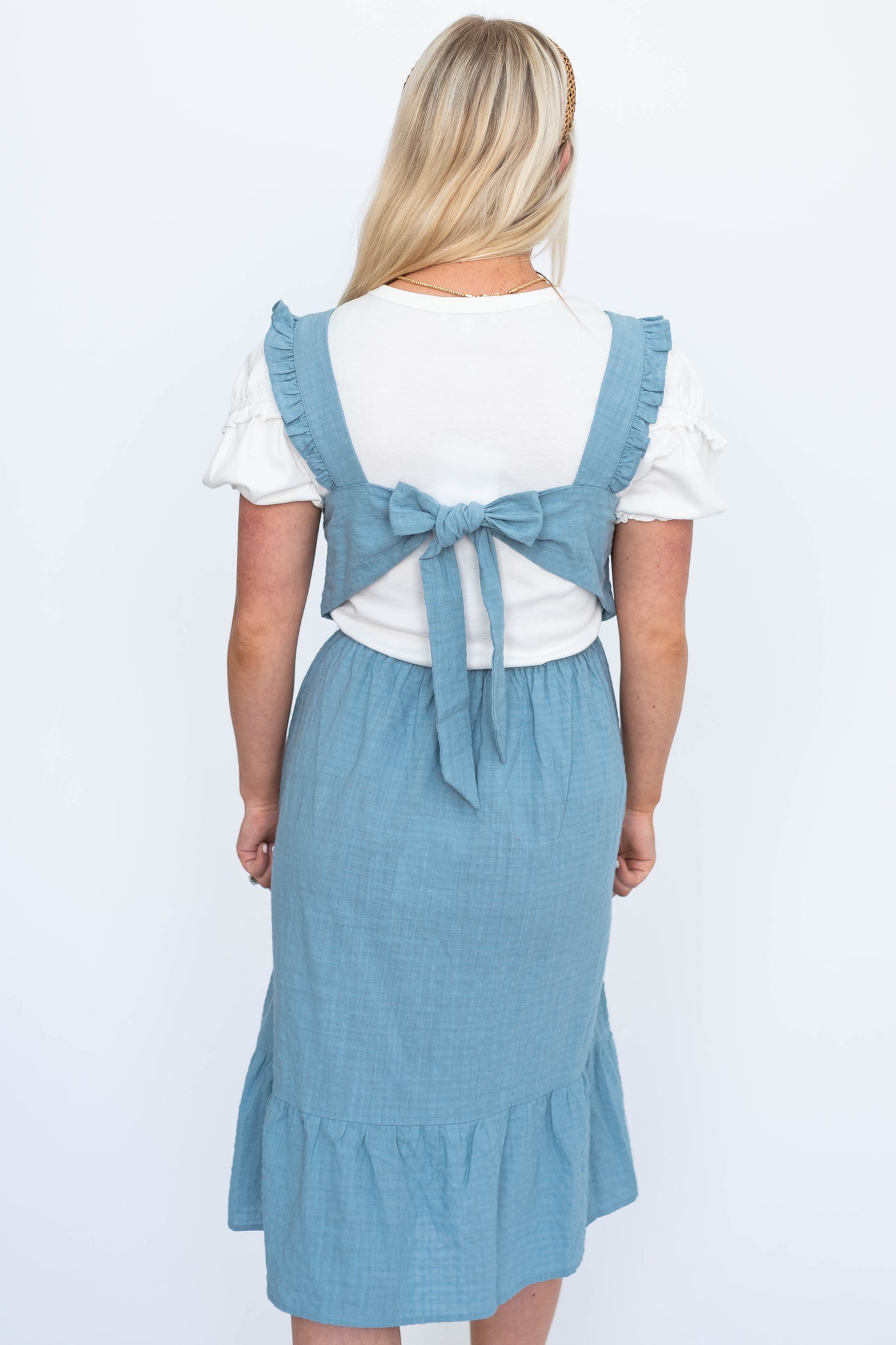 Back view of a jumper dress that ties in the back