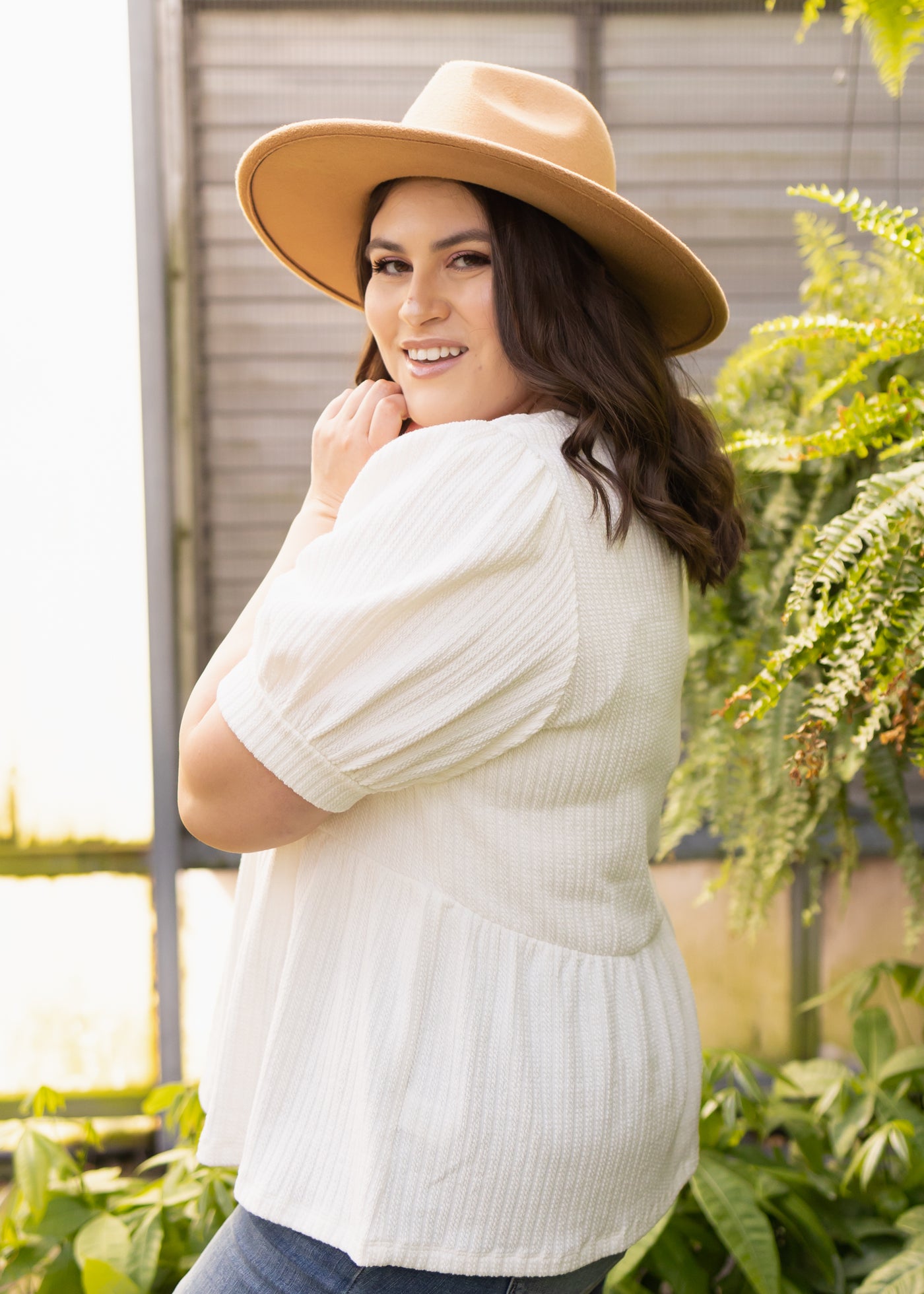 Side view of a plus size ivory top