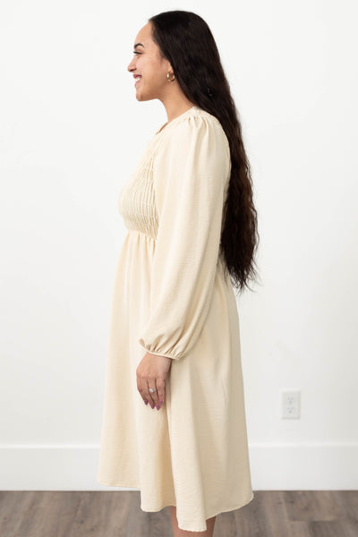 Side view of a cream lace dress