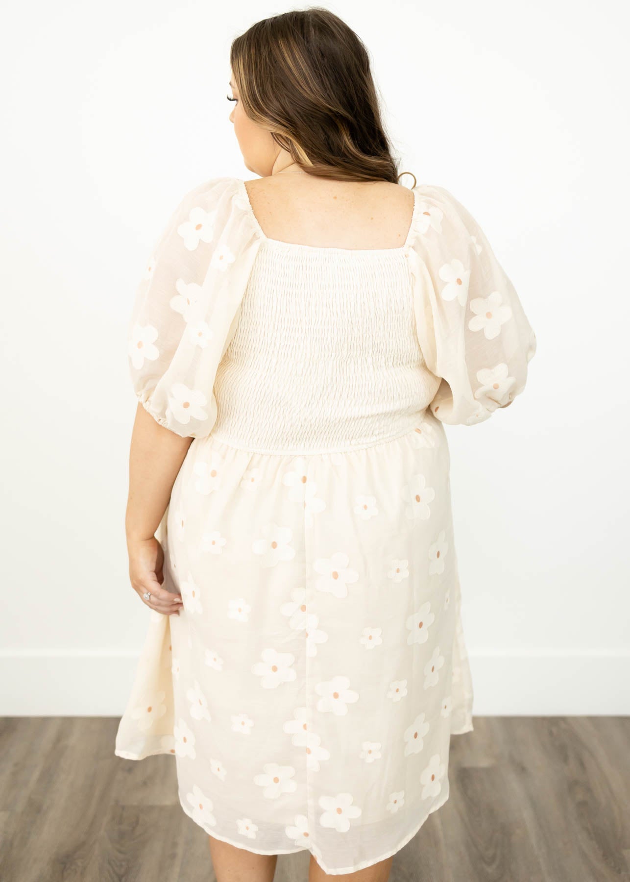 Back view of a plus size cream floral dress