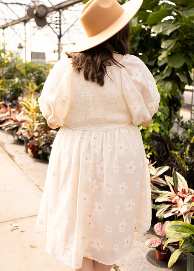 Back view of a plus size cream floral dress