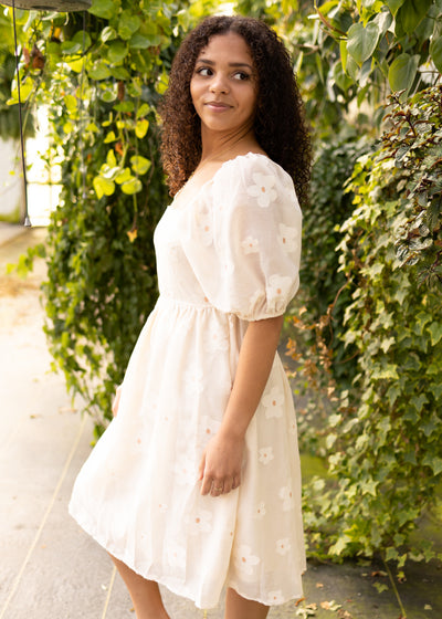 Side view of a cream floral dress
