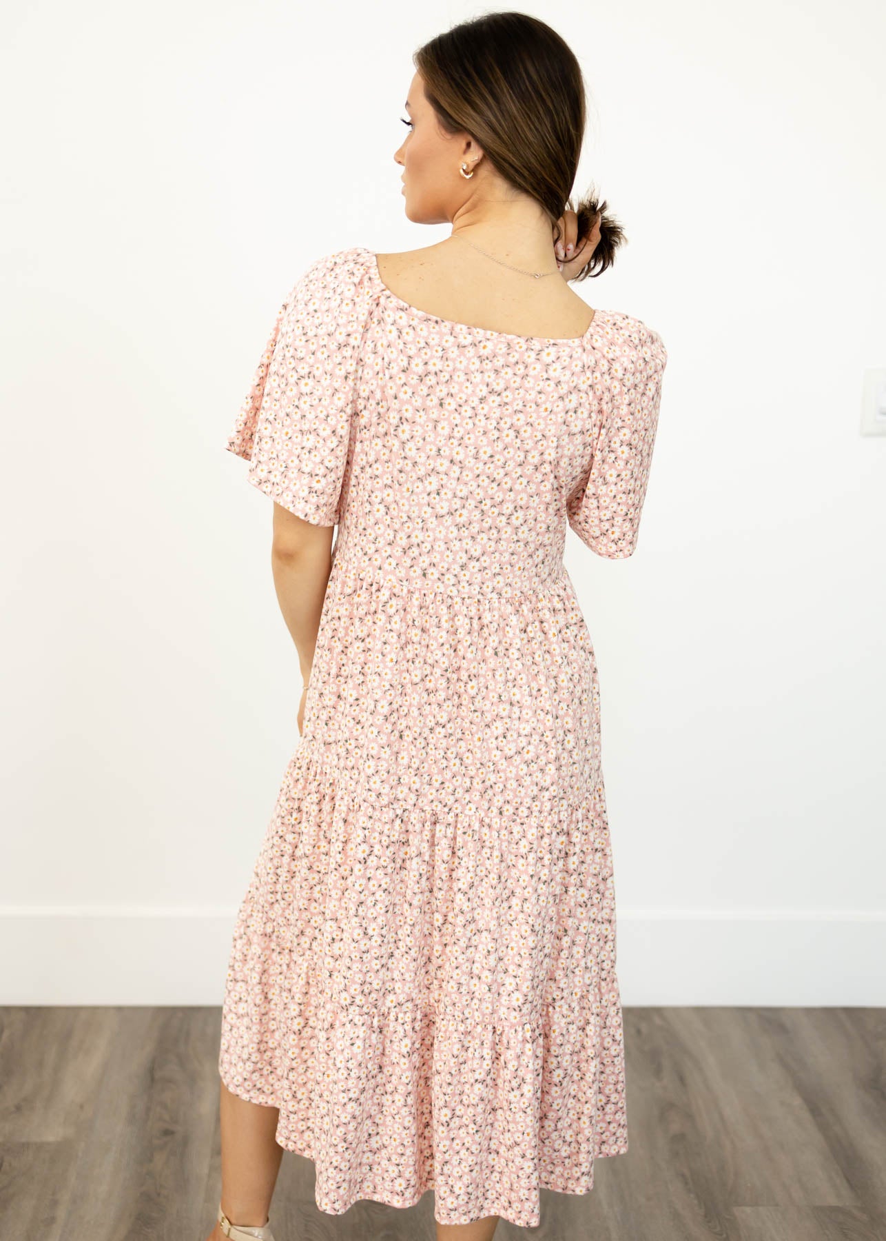 Back view of a blush floral dress