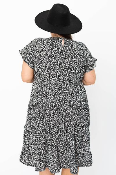 Back view of a plus size black floral dress
