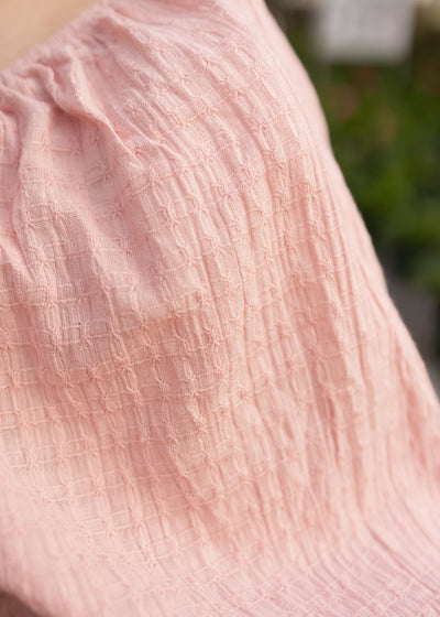 Sleeve of a dusty pink dress