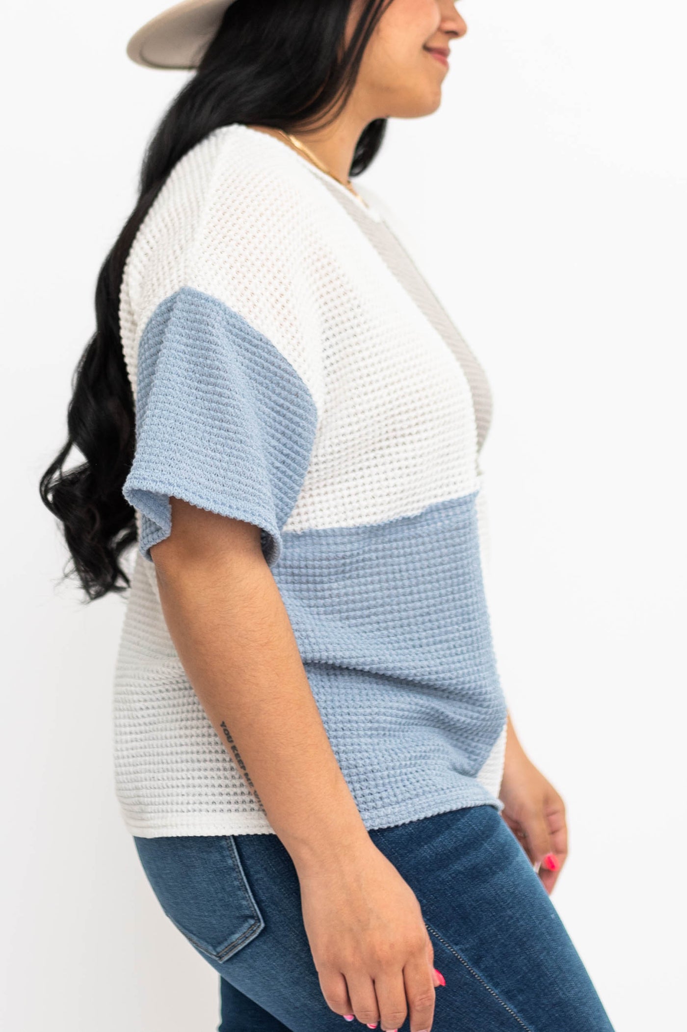 Side view of a blue knit top