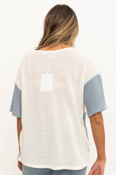 Back view of a blue knit top