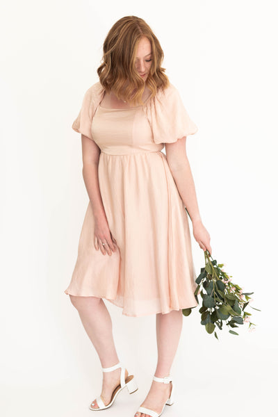 Short sleeve medium blush dress that is knee length