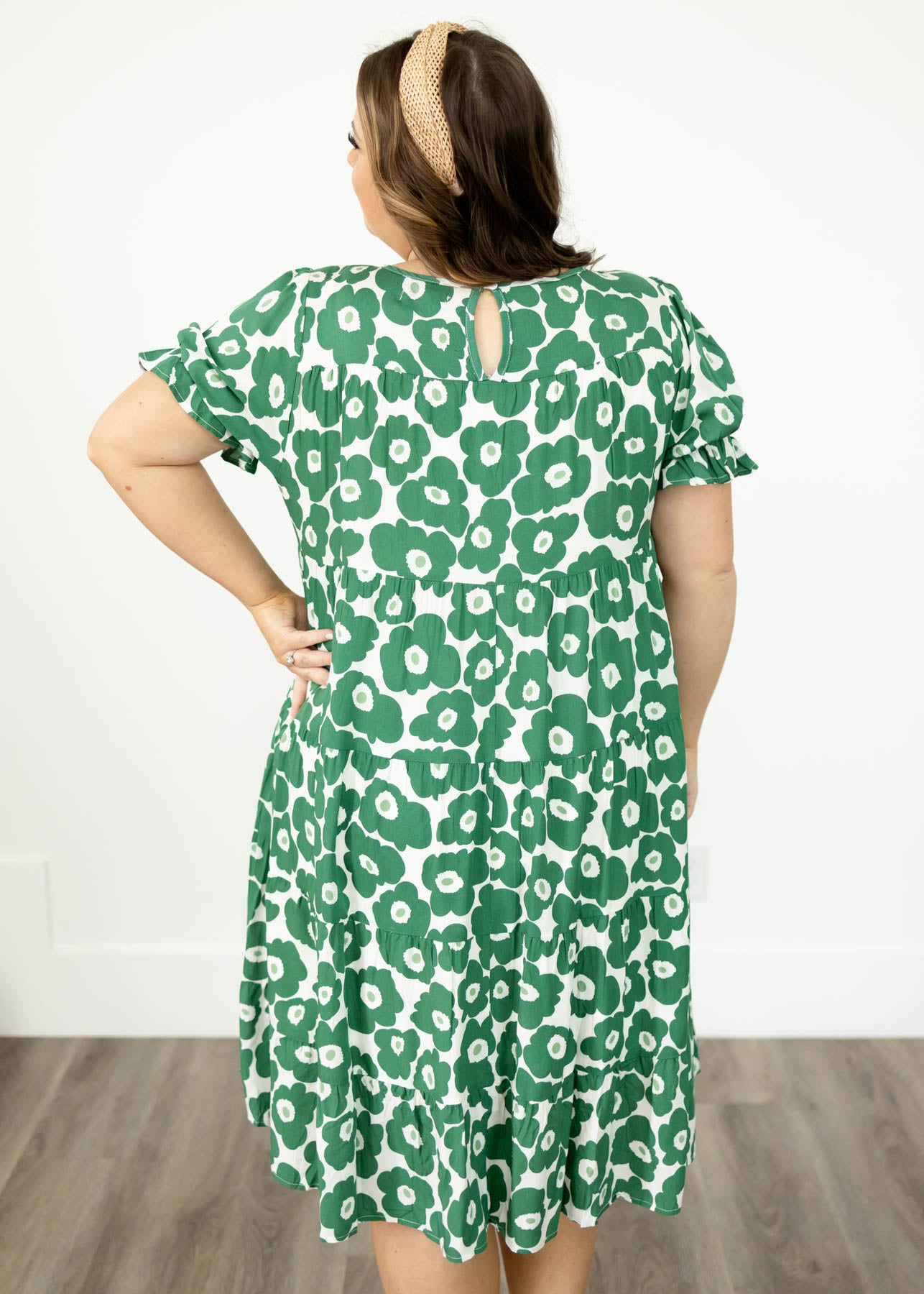 Back view of a plus size green floral dress