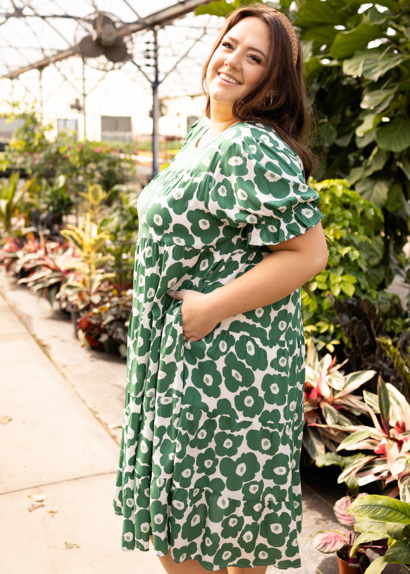 Side view of a short sleeve plus size green floral dress