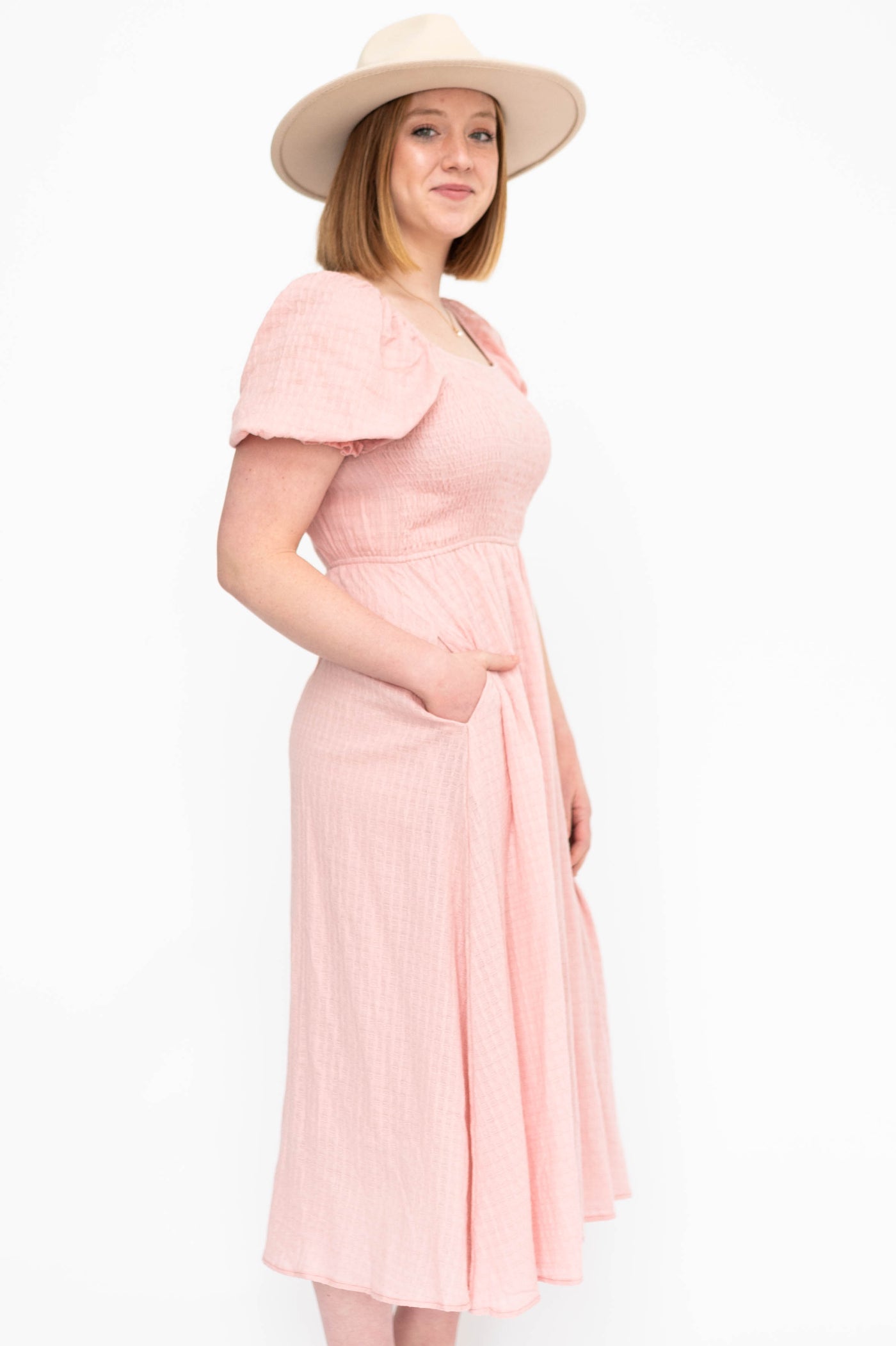 Side view of a mauve dress with short puff sleeves