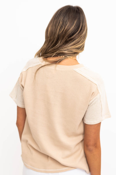 Back view of a short sleeve beige top