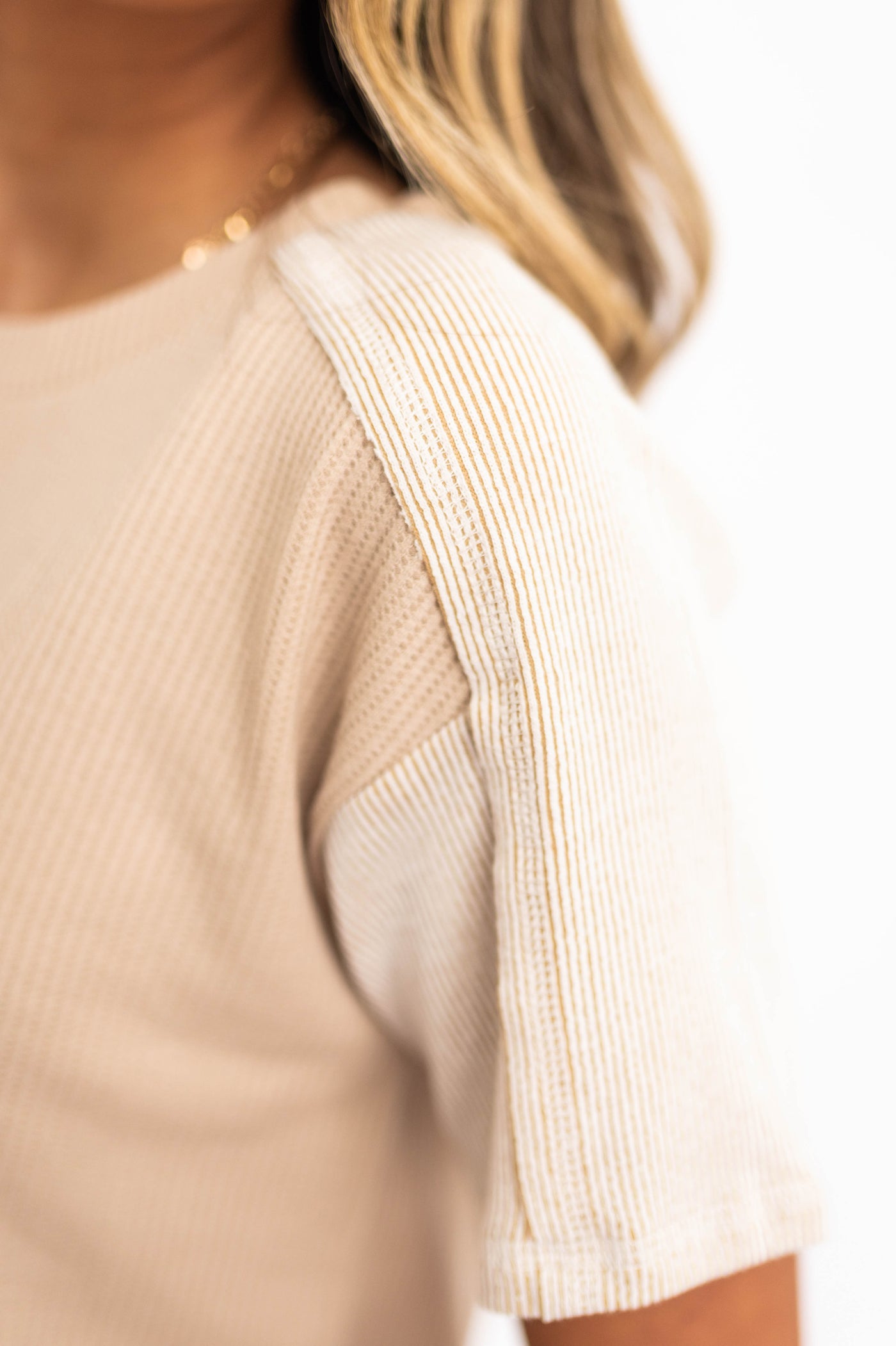 Sleeve of a beige top
