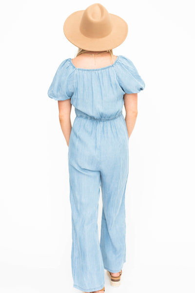 Back view of a short sleeve denim jumpsuit