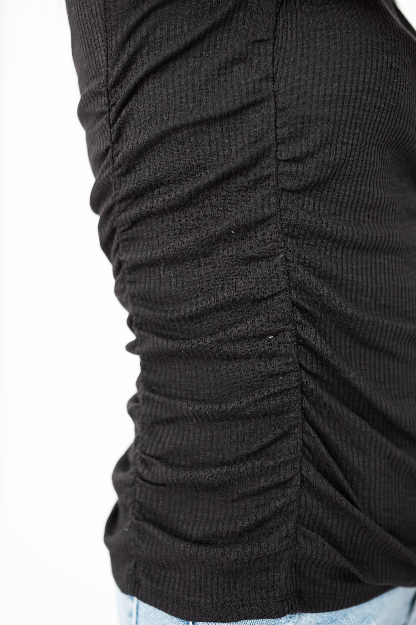 Gathered side of a black top