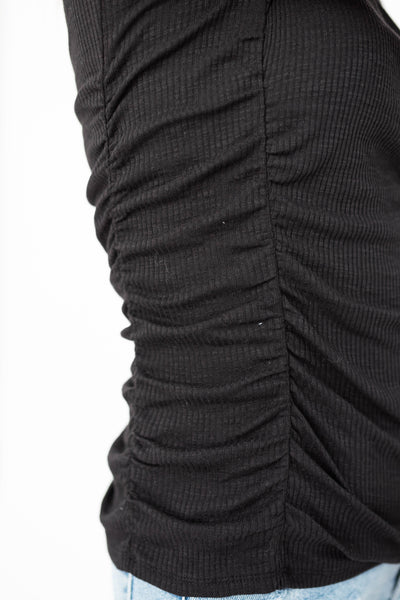 Gathered side of a black top